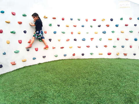新新公園のすべり台の壁面にはスリルを求める子供たちの興味を引くクライミングウォールが設置されています。(写真/ Daria Lin)