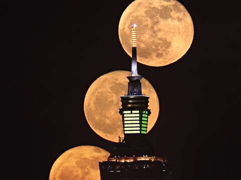 吳昆臻先生拍攝之滿月與台北101大樓(圖片來源：臺北市立天文科學教育館)