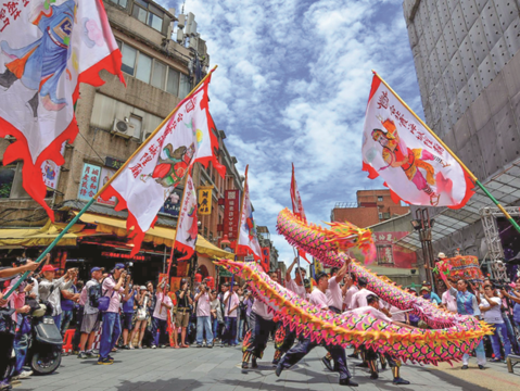 Several different folk performance groups, such as dragon dancers, join the parade honoring the City God.