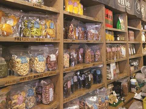 On the shelves there are a variety of dried fruits and snacks, displayed neatly and cleanly.