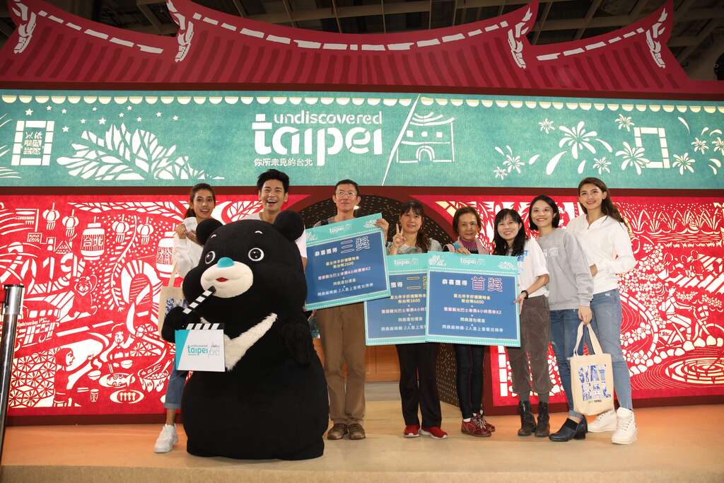 台北国际旅展台北馆造势大放送，熊赞、观光传播局副局长陈誉馨、食尚达人杨子仪、纸雕艺术家成若涵、熊赞与获奖民众开心合影。.JPG