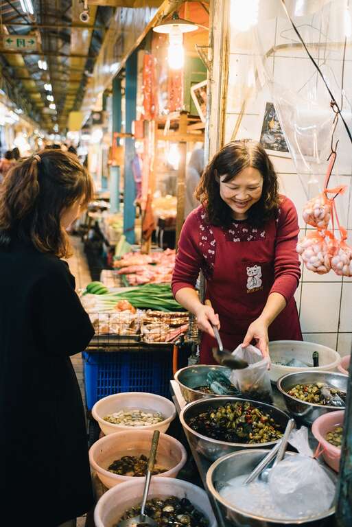 1.卖腌蚬仔的老板娘，笑容可掬地和客人分享独家配方。