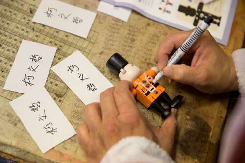 Mayor Ko leaves his signature on a nutcracker bear.